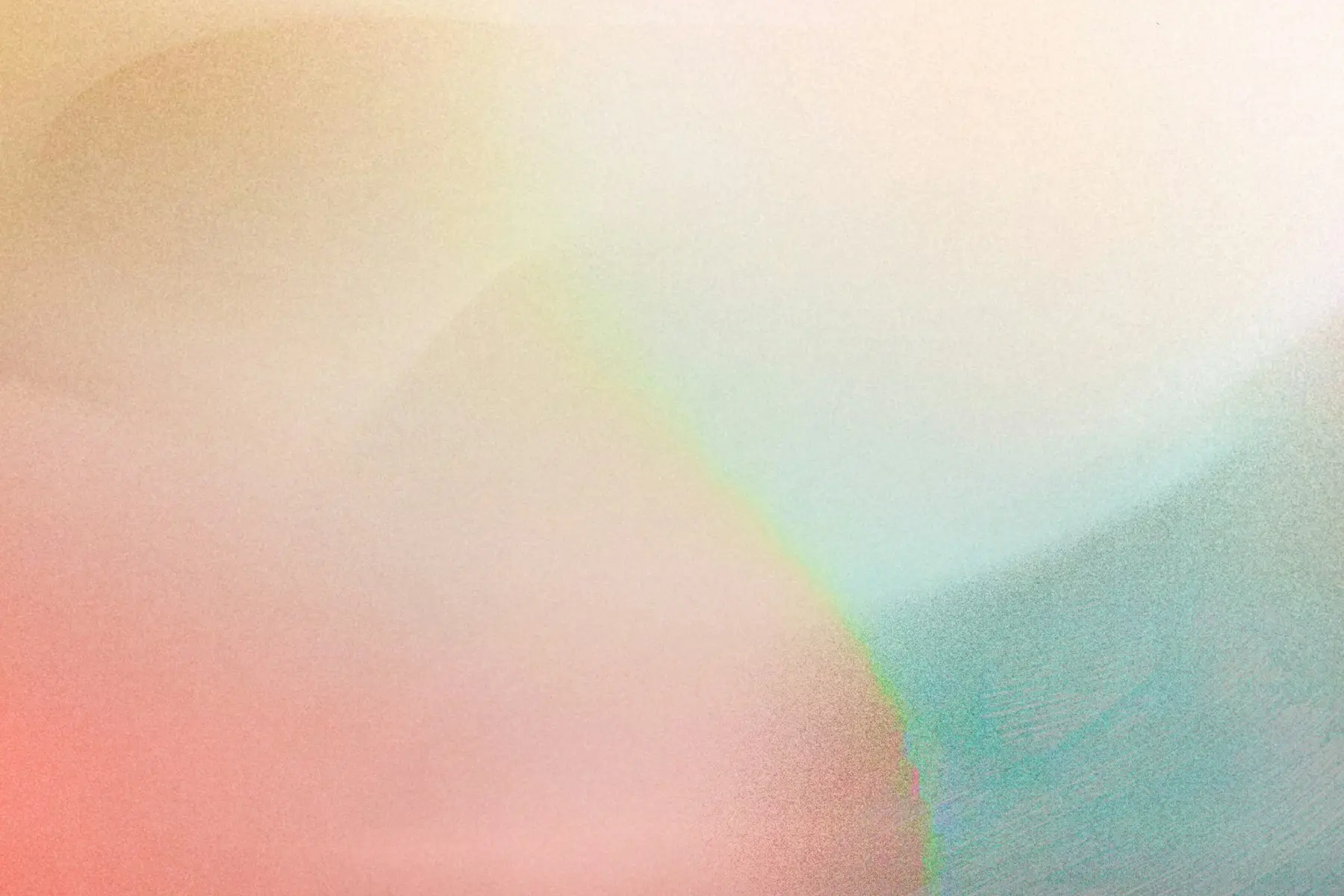 Soft pastel pink, green, and blue light blending across a grainy field